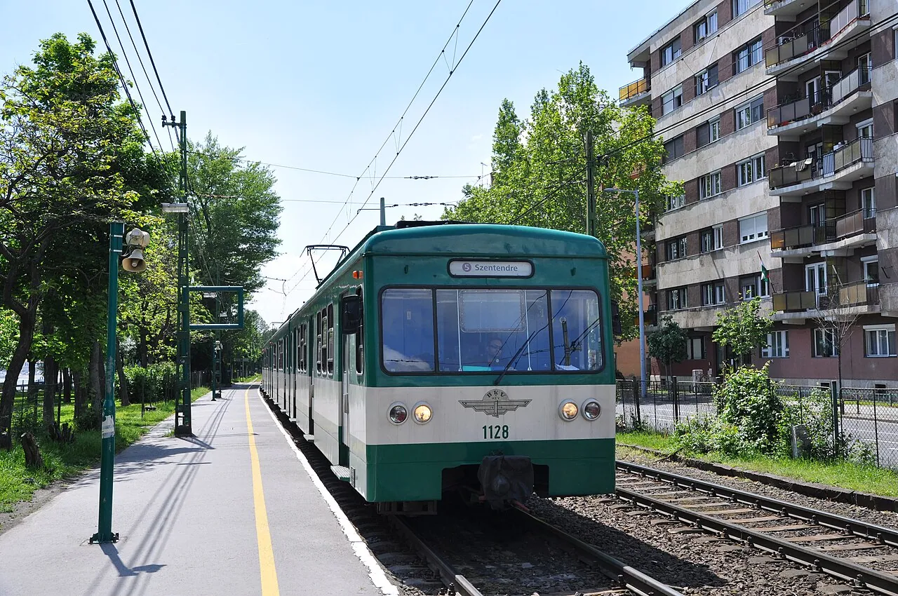 Grönt HÉV-pendeltåg vid en hållplats i Budapest.